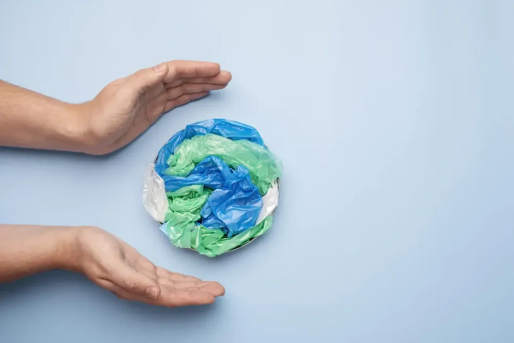 close-up-hand-with-plastic-earth